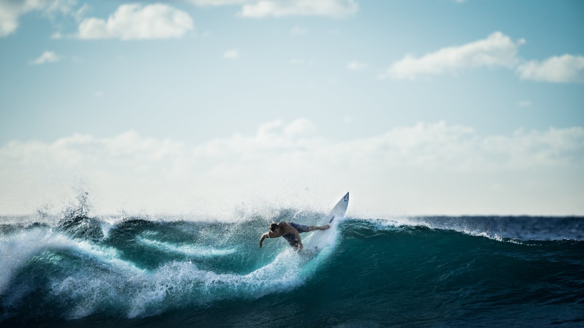 surfing a wave at Bali beachfront resort